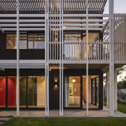 Dark stained timber weatherboards are contrasted with white-washed 