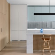 The kitchen island's waterfall benchtop has a chunky 