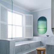 A step-up bath looks out onto the clouds. 