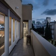 A narrow balcony provides expansive city views - apartment, architecture, building, condominium, home, house, property, real estate, sky, window, black