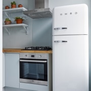 Saving space is essential in apartments – especially gas stove, home appliance, kitchen, kitchen appliance, kitchen stove, major appliance, microwave oven, product, product design, refrigerator, small appliance, gray, white