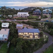 The home sits comfortably on its section - aerial photography, bird's eye view, city, cottage, estate, home, house, neighbourhood, property, real estate, residential area, sky, suburb, tree, urban area, village, black