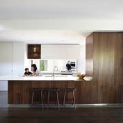 This wood kitchen serves as the perfect contrast cabinetry, countertop, floor, flooring, house, interior design, kitchen, real estate, room, wood flooring, white