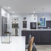 In this sleek kitchen project by designer Kira countertop, kitchen design, kitchen, Kira Gray,  Fyfe Kitchens,  concrete benchtop