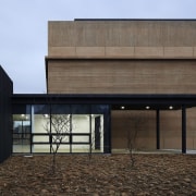 The lobby is welcoming, with floor to ceiling architecture, building, daylighting, facade, house, black