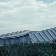 The arena was supposed not only to serve architecture, building, cloud, corporate headquarters, daytime, headquarters, roof, sky, structure, white