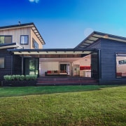 A wide shot of the entire Waitoki home cottage, elevation, estate, facade, home, house, property, real estate, residential area, siding, blue