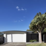A view of the street-facing facade during the architecture, cottage, estate, facade, home, house, property, real estate, residential area, sky, tree, villa, blue
