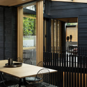 This central kitchen and accompanying dining area follows architecture, home, house, interior design, patio, porch, window, wood, black, Strachan Architects, 