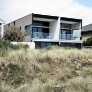 Standing as one unit, the townhouse doesn't intrude architecture, building, facade, home, house, property, real estate, residential area, white