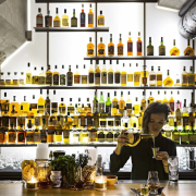 This new whiskey bar takes advantage of a bar, distilled beverage, drink, liquor store, white, black