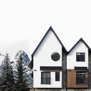 Tall and narrow, the lodge is a perfect architecture, building, cottage, elevation, facade, home, house, property, real estate, roof, siding, sky, window, white