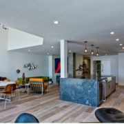 A spacious living area joins the kitchen - apartment, ceiling, estate, home, house, interior design, living room, lobby, property, real estate, gray