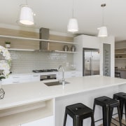 This Sentinel Homes showhome features a kitchen and countertop, cuisine classique, home, interior design, kitchen, real estate, room, gray
