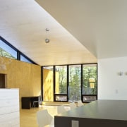 The high ceilings are church-like and flood the architecture, ceiling, daylighting, floor, home, house, interior design, real estate, roof, wall, window, gray