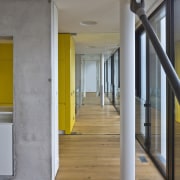 It's a long home, but never feels dark apartment, architecture, column, daylighting, floor, flooring, hardwood, home, house, interior design, loft, stairs, structure, wall, wood, wood flooring, gray, brown