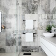 This unique wall pattern serves to set the architecture, bathroom, ceramic, floor, flooring, interior design, room, tap, tile, wall, gray, white