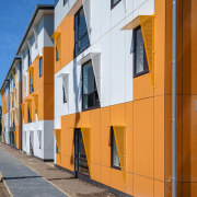 Contemporary shared kitchen and laundry amenities are all apartment, architecture, building, city, door, facade, home, house, line, neighbourhood, real estate, residential area, sky, town, urban area, wall, window, yellow, brown