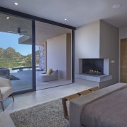 The master bedroom features a breathtaking outlook architecture, fireplace, floor, hearth, house, interior design, living room, property, real estate, room, gray