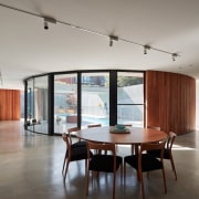 Looking past the dining room into the pool architecture, ceiling, daylighting, floor, flooring, house, interior design, living room, loft, property, real estate, table, gray
