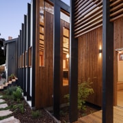 A view from the garden into the kitchen architecture, facade, home, house, property, real estate, siding, wood, black