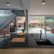 The kitchen flows into the dining space and architecture, countertop, house, interior design, kitchen, real estate, gray