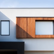 The wood framing this window makes for an architecture, building, facade, home, house, product design, white