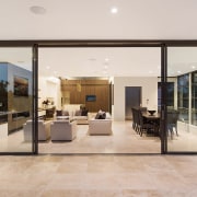 On this top floor of a three-level Sydney door, floor, flooring, house, interior design, lobby, real estate, window, gray