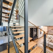 The stairway is a centrepiece for the living handrail, interior design, loft, real estate, stairs, gray