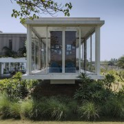 This living area hangs above the lush vegetation architecture, building, corporate headquarters, estate, home, house, real estate, tree, teal