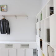 There's room for shoes, coats, books and more architecture, floor, furniture, interior design, product design, room, shelf, shelving, wall, gray