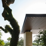 The simple structure doesn't intrude on the landscape architecture, building, facade, house, outdoor structure, roof, sky, structure, tree, white, black