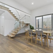 The dining table doesn't intrude – important in architecture, ceiling, daylighting, estate, floor, flooring, hardwood, house, interior design, laminate flooring, property, real estate, stairs, wood, wood flooring, gray