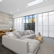 A view of the concrete wall and skylights architecture, ceiling, home, house, interior design, living room, property, real estate, room, wall, window, gray