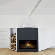 The fireplace includes storage cupboards and a place fireplace, hearth, home appliance, interior design, product design, white