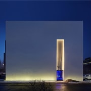 Your is immediately drawn to the glowing entrance architecture, atmosphere, building, corporate headquarters, daytime, reflection, sky, skyscraper, tower, tower block, blue