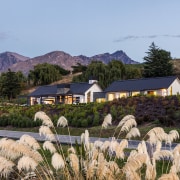 This home is stunning in so many ways. cottage, farm, flower, home, house, landscape, mountain, plant, real estate, rural area, sky, spring, tree, teal, brown