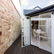 Large glass doors lead out to the courtyard architecture, daylighting, house, interior design, property, real estate, wall, white