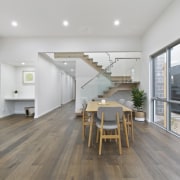 The wood floors run the length of the architecture, floor, flooring, house, interior design, real estate, wood flooring, gray