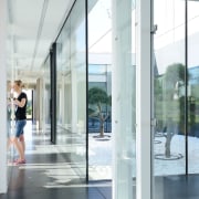 A courtyard inside the office is a source door, floor, glass, window, white