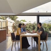 The entire kitchen/dining space is open and spacious, furniture, house, interior design, real estate, table, window, gray