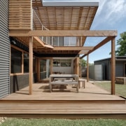 Wood slats line the upper level of this architecture, deck, elevation, facade, house, outdoor structure, real estate, residential area, siding, brown