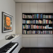 The library and study has a classical feeling bookcase, furniture, shelf, shelving, gray, black