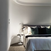 Curved walls lead the eye to the bed architecture, bed frame, bedroom, ceiling, daylighting, floor, flooring, furniture, home, house, interior design, lighting, room, wall, window, wood, gray