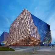 The different surfaces seem to blend together - architecture, building, condominium, corporate headquarters, daytime, facade, headquarters, landmark, metropolitan area, sky, skyscraper, tower block, teal