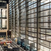 The glass-walled atrium in the Courts Building at architecture, building, condominium, facade, glass, window, black, gray