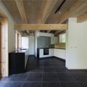 Large, dark tiles run throughout the ground floor architecture, ceiling, daylighting, estate, floor, flooring, house, interior design, property, real estate, wood flooring, gray, brown