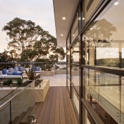 Sandstone featuring on the facade of this hillside apartment, architecture, balcony, condominium, daylighting, handrail, home, house, interior design, penthouse apartment, property, real estate, roof, window, brown