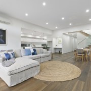 While the kitchen isn't the focal point of ceiling, floor, interior design, living room, penthouse apartment, property, real estate, room, gray