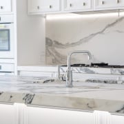 This new kitchen in a villa renovation features countertop, floor, flooring, interior design, kitchen, tap, tile, gray, white